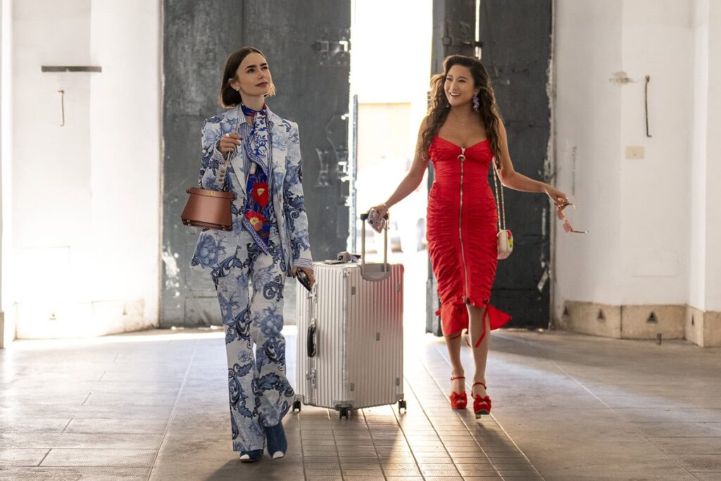 Emily's blue print suit + Mindy's red dress on Emily In Paris